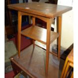 An Edwardian oak foldover baize lined swivel two-tier games table, width 51cm