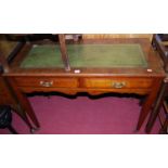 A circa 1900 mahogany and gilt tooled green leather inset two-drawer writing table, w.105cm