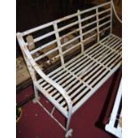 A 19th century and later white painted wrought iron slatted four seater garden bench (one end raised