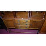 An early 20th century oak dresser base, having three central drawers flanked by recessed panel