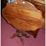 A 19th century Continental mahogany shaped tilt-top pedestal breakfast table, raised on reeded