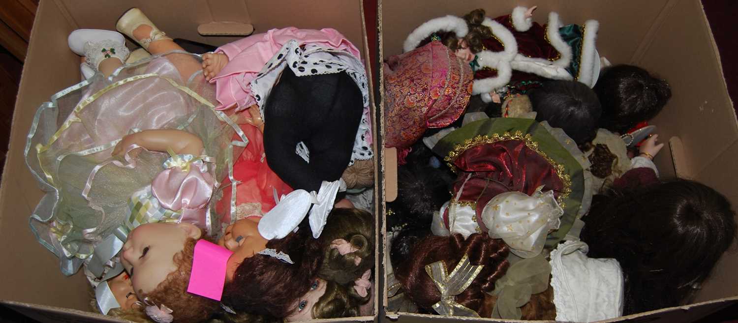 Two boxes containing a large quantity of modern porcelain dolls, all fully clothed, some with