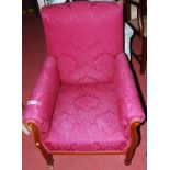 An Edwardian mahogany and satinwood inlaid parlour armchair, upholstered in a purple silk floral