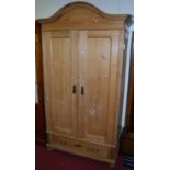 A French pine arch topped double door armoire, having single long lower drawer on bun supports, w.