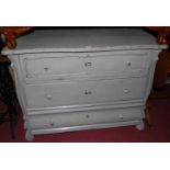 A 19th century provincial French and later grey painted pine serpentine front three drawer commode