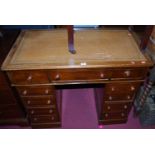 A small Victorian mahogany and gilt tooled tan leather inset round cornered twin pedestal desk,