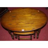 A contemporary moulded oak nest of three oval occasional tables, the largest w.82cm