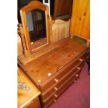 A modern pine chest of four long drawers, with similar swing dressing mirror (2)