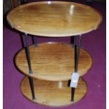 An oval faded mahogany three-tier whatnot, each tier with slightly raised edge, supported on tubular