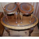 An Indian oval hardwood nest of three occasional tables, each having floral carved and pierced
