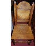 A set of six joined oak panelled seat dining chairs (4+2)