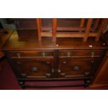 A 1920s moulded oak ledgeback sideboard, w.120cm