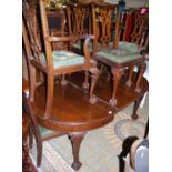 An early 20th century mahogany D-end dining suite, comprising; extending dining table with wind-