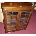 A 1930s small oak lead glazed double door bookcase, width 81.5cm