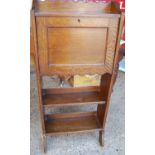 A 1930s oak narrow students bureau, the hinged fall front over twin lower open tiers, width 52.5cm