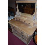 An Edwardian satin walnut swing mirrorback dressing chest, having two short over two long drawers,