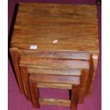A contemporary stained hardwood nest of three occasional tables, the largest w.45cm