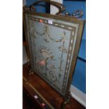 An Edwardian lacquered brass and classical floral inset fire screen, width 52cmCondition report: