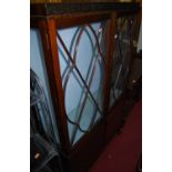 A 1930s mahogany china display cabinet, the twin astragal glazed upper doors over lower panelled