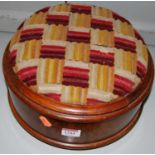 A Victorian figured walnut and upholstered inset circular hinge-top low footstool, with inset