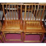 A set of four Chinese stained elm panelled seat stickback dining chairs