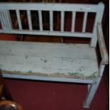 A 19th century rustic pine and later grey painted long waiting room bench, with slatted back and