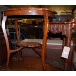 An early 20th century walnut shaped two-tier occasional table, having relief carved floral frieze