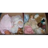 Two boxes containing a large quantity of modern porcelain dolls, all fully clothed, some with