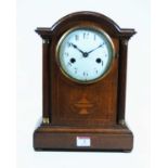 An early 20th century oak cased mantel clock, having an 8 day movement, the enamel dial showing