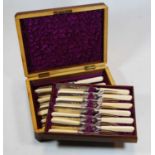 A cased set of twelve Victorian silver plated and ivorine handled dessert knives and forks, case w.