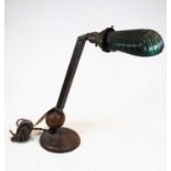 An early 20th century adjustable copper desk lamp, with shaped green overlaid glass shade, height