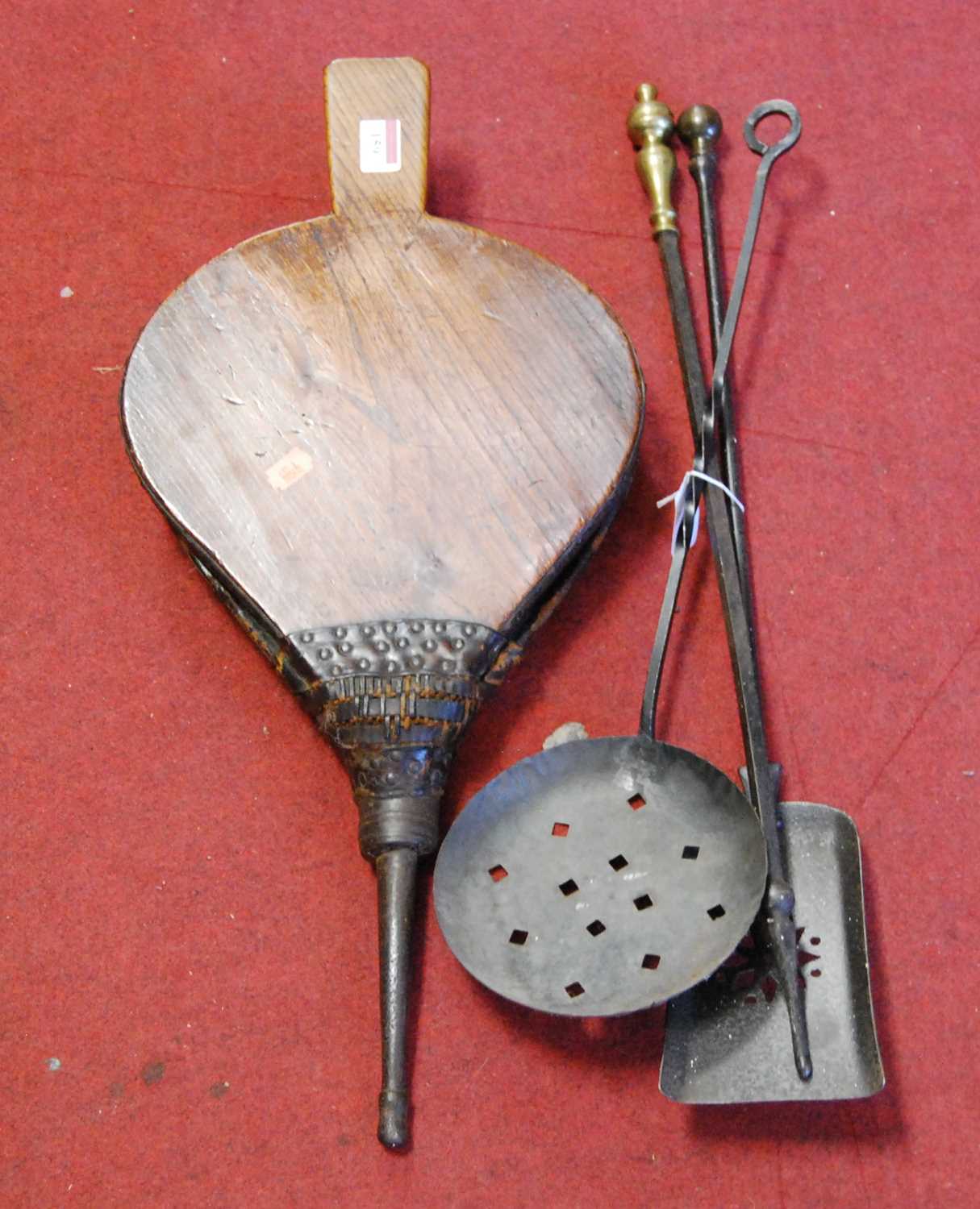 A pair of elm bellows together with a set of cast iron fire tools