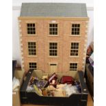 A modern faux brick-fronted three storey dolls house; together with a box of assorted dolls house