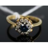 An 18ct gold sapphire and diamond flowerhead cluster ring, 4.1g, size N/OCondition report: Very