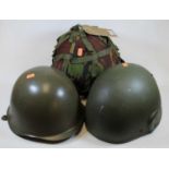 A 1980s GS MkVI combat helmet, size large, stock number 84115/99/132/6007; together with two other