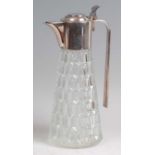 A 1930s silver plated and clear moulded glass bodied claret jug, having plain elongated handle, with