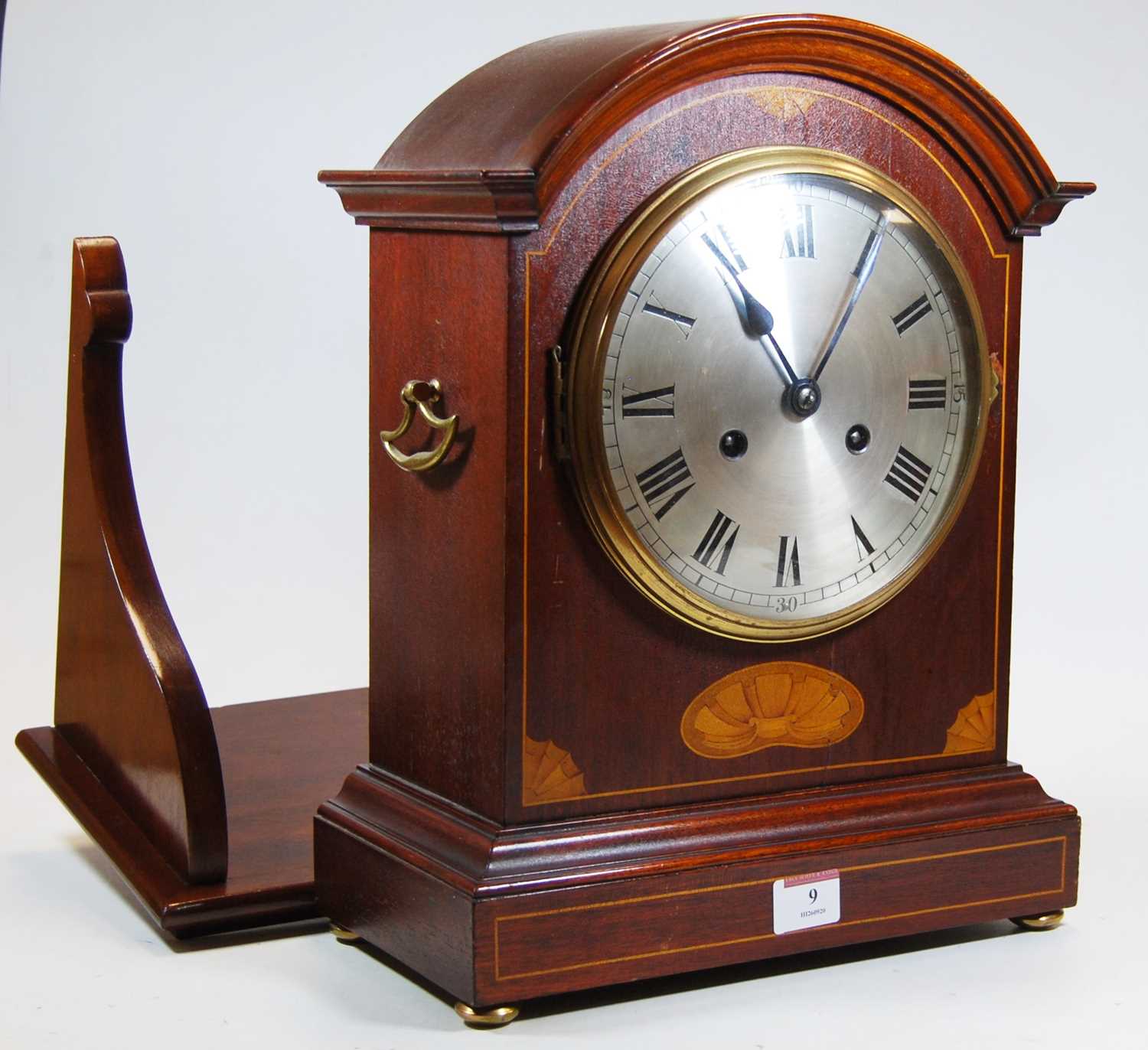 An early 20th century inlaid mahogany cased bracket clock, the silvered dial showing Roman numerals,