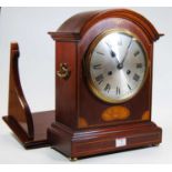 An early 20th century inlaid mahogany cased bracket clock, the silvered dial showing Roman numerals,