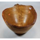 A large rustic carved oak fruit bowl, dia. 40cm