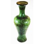 A 20th century Japenese or Chinese green glazed vase of baluster form, profusely decorated with