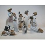 A collection of Nao porcelain ornaments to include children, puppies, and rabbit (8)Condition