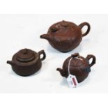 A Chinese Yixing teapot and cover, height 10.5cm, together with two smaller examples (3)