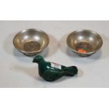 A Chinese green glazed earthenware bird; together with two silvered metal small dishes, each signed,