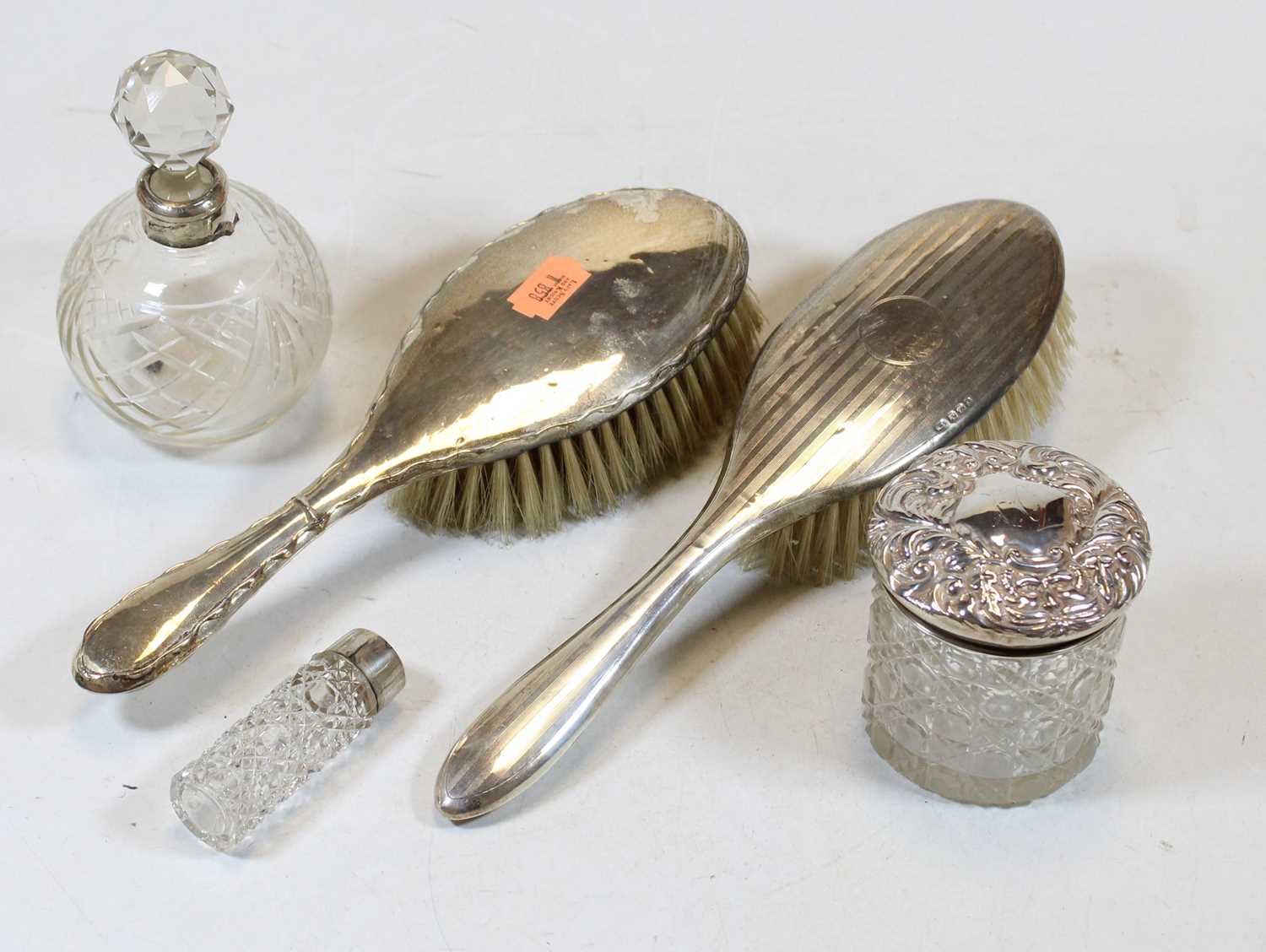 Two silver backed hairbrushes; together with an Edwardian scent bottle with silver collar; and two