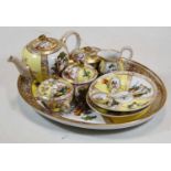 An Augustus Rex porcelain miniature cabaret set, comprising tea-for-two service on oval tray, all
