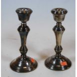 A pair of turned silver candlesticks on loaded bases, h.20.5cm