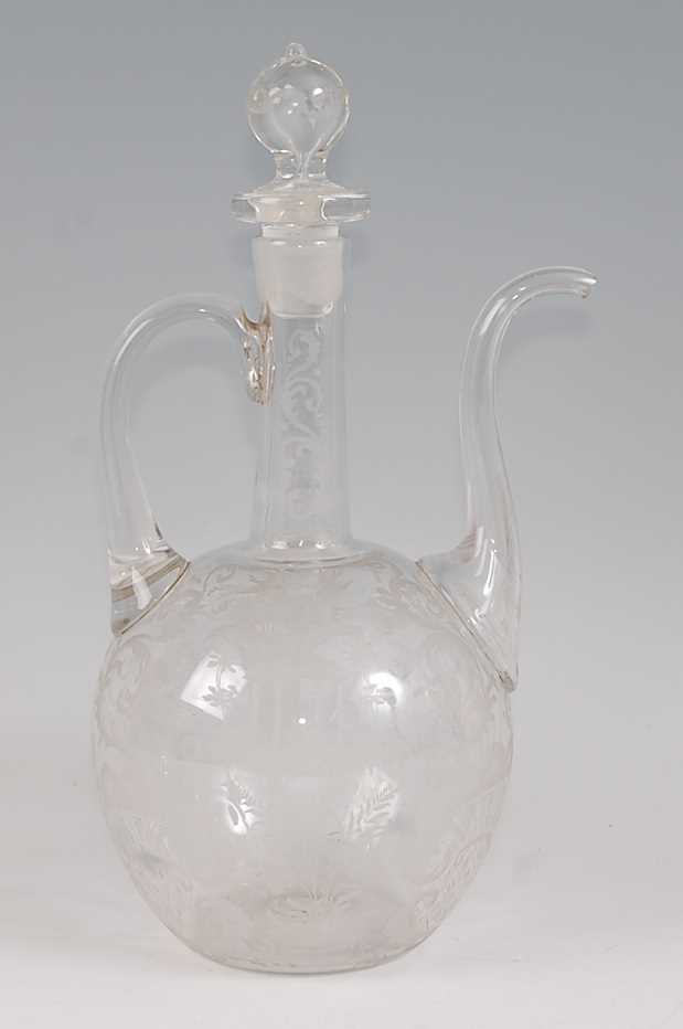 An Ottoman Empire style glass ewer and stopper, having elongated spout and high loop handle, all-