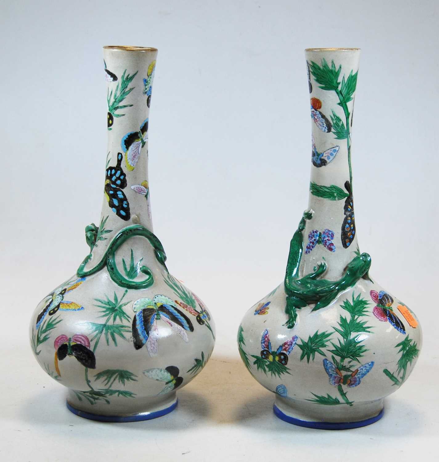 A pair of eastern earthenware vases, each enamel decorated with butterflies, height 33cmCondition