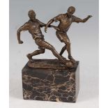 A contemporary bronze study of two association football players contesting for the ball, mid-