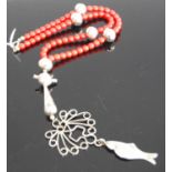 A contemporary white metal (stamped 925) and faux coral necklace with fish pendant